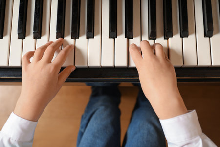 Little child playing piano, above view. music lessonsの写真素材