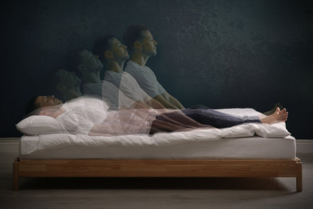 Somnambulist rising from bed near dark wall indoors, multiple exposure. sleepwalkingの写真素材