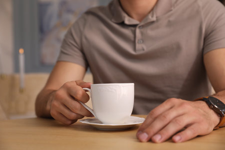 Man with cup of coffee at cafe in the morning, closeupの写真素材