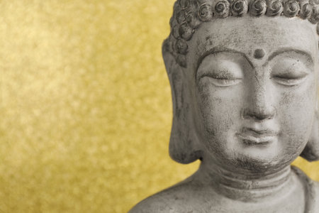 Buddha statue on golden background, closeup. Space for textの写真素材