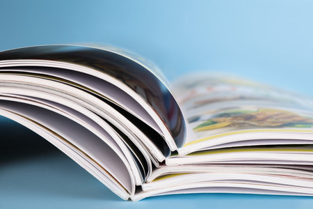 Stack of magazines on light blue background, closeupの写真素材