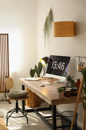 Room interior with comfortable workplace. modern computer on wooden desk