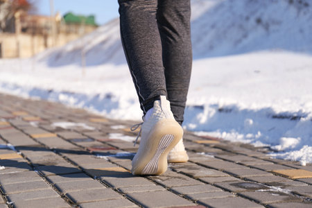 Woman running outdoors on winter day, closeup. sports exercisesの写真素材