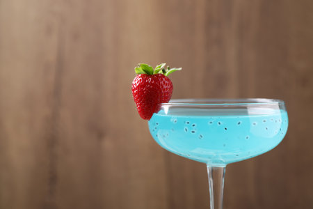 Refreshing light blue cocktail with strawberry on blurred background, space for textの写真素材
