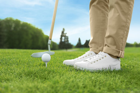 Person playing golf on green course, closeupの写真素材