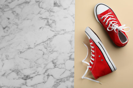 Pair of red sneakers on color background, flat lay. Space for textの写真素材