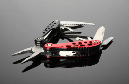 Modern compact portable multitool on gray table