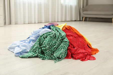 Pile of dirty clothes on floor indoorsの写真素材