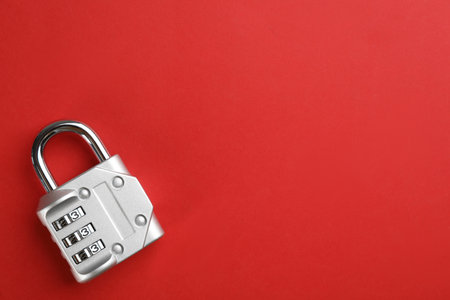 Modern combination lock on red background, top view. Space for textの写真素材