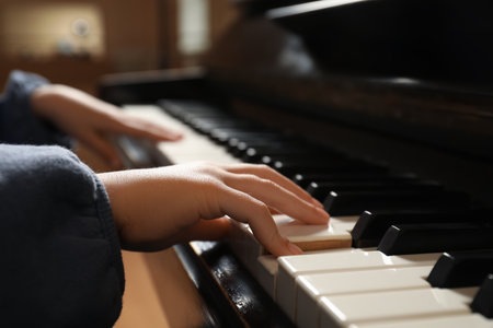 Little child playing piano, closeup. music lessonsの写真素材