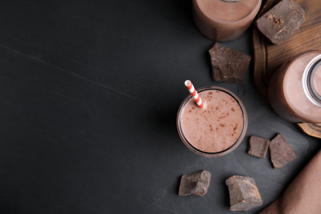 Delicious chocolate milk on black table, flat lay. Space for textの写真素材