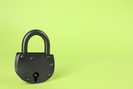 Vintage padlock on light green background. Space for textの写真素材