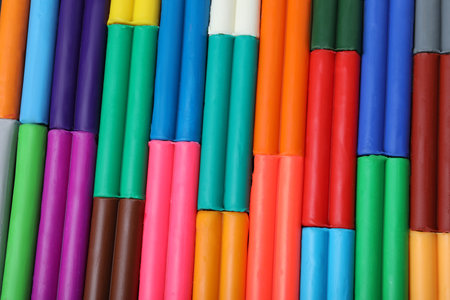 Many different colorful plastic pieces as background, top viewの写真素材