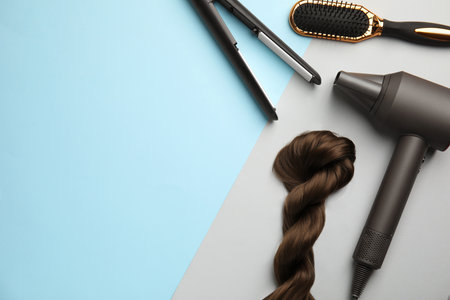 Flat lay composition with hair dressing equipment on color background. Space for textの写真素材