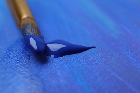 Brush with blue paint on abstract picture, closeup. Space for textの写真素材