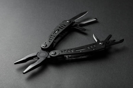 Compact portable multitool on black background, closeupの写真素材