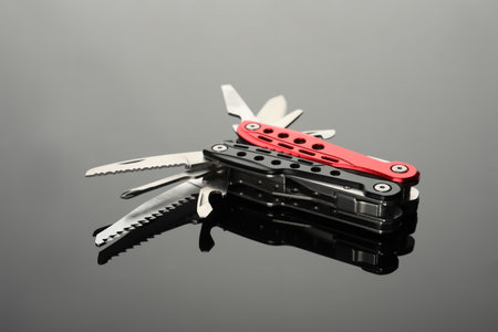 Modern compact portable multitool on gray tableの写真素材