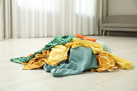 Pile of dirty clothes on floor indoorsの写真素材