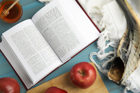 Flat lay composition with Rosh Hashanah holiday symbols on turquoise wooden tableの写真素材