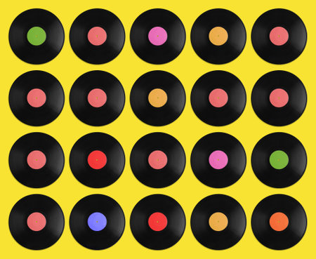 Set with vintage vinyl records on yellow background, top viewの写真素材