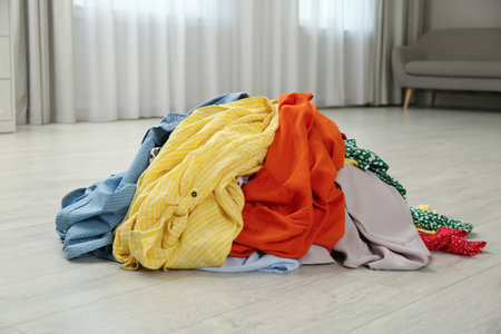 Pile of dirty clothes on floor indoorsの写真素材