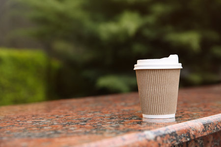 Takeaway paper coffee cup outdoors, space for textの写真素材