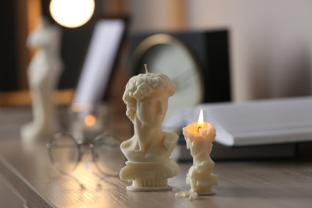 Beautiful David bust candles on table indoorsの写真素材