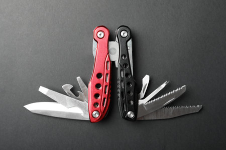 Compact portable multitool on gray background, top viewの写真素材