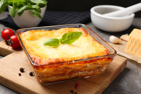 Tasty cooked lasagna in baking dish on gray table, closeupの写真素材