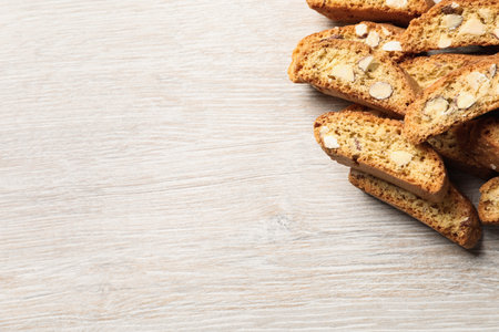 Traditional Italian almond biscuits (Cantucci) on white wooden table, flat lay. Space for textの写真素材