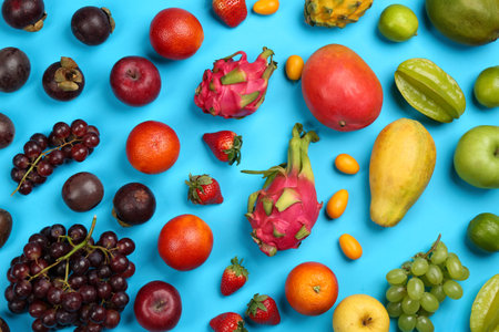 Assortment of fresh exotic fruits on light blue background, flat layの写真素材