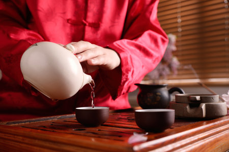 Master conducting traditional tea ceremony at table, closeupの写真素材