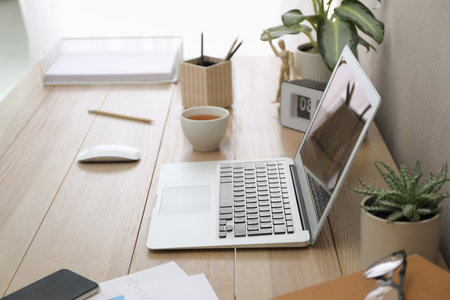 Stylish workplace with laptop on wooden desk. interior designの写真素材