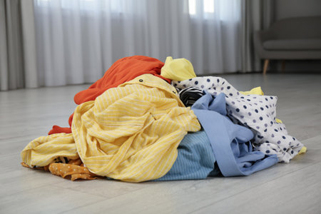 Pile of dirty clothes on floor indoorsの写真素材