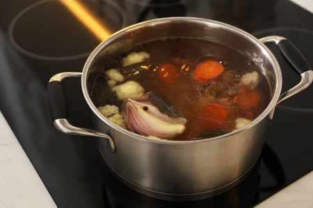 Pot with delicious bouillon on stove, closeup. homemade recipeの写真素材