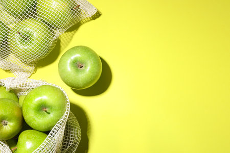 Ripe apples on light green background, flat lay. Space for textの写真素材