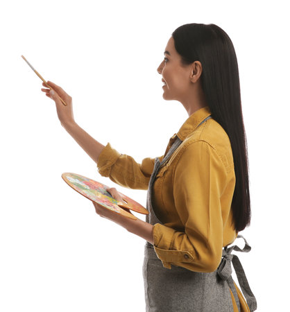 Young woman drawing with brush on white backgroundの写真素材