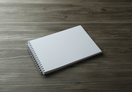Blank paper brochure on wooden table. Mockup for design