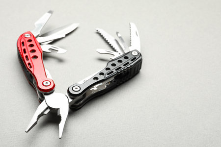 Compact portable multitool on light gray background, closeup. Space for textの写真素材