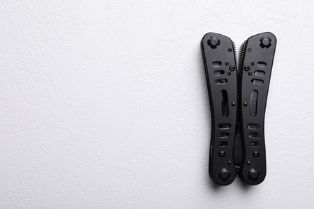 Modern compact portable multitool on white table, top view. Space for textの写真素材