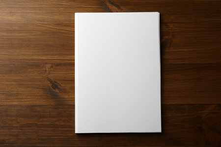 Blank paper brochure on wooden table, top view. Mockup for designの写真素材