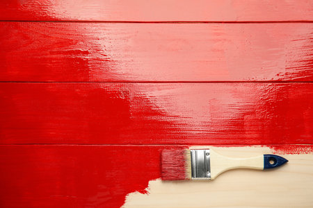Brush on red painted wooden surface, top view. Space for textの写真素材