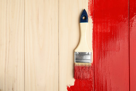 Brush on red painted wooden surface, top view. Space for textの写真素材