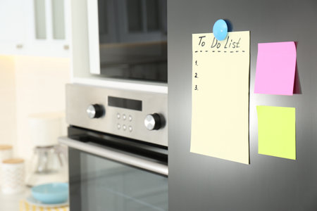 Blank To do list and sticky notes on fridge in kitchen. Space for textの写真素材