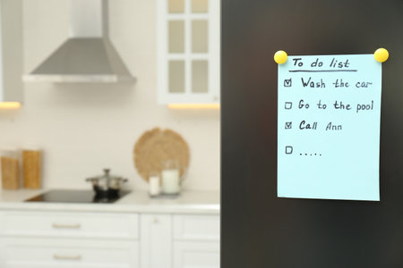 To do list on fridge in kitchen. Space for textの写真素材