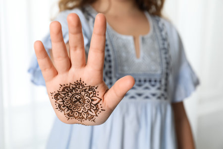 Little girl with henna tattoo on palm, closeup and space for text. traditional mehndi ornamentの写真素材