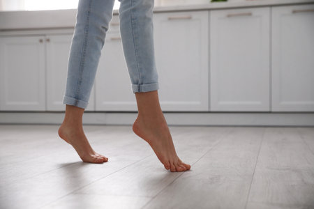Barefoot woman at home, closeup. floor heating systemの写真素材