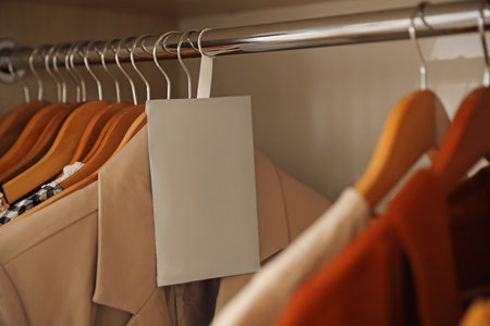 Scented sachet and clothes hanging in wardrobeの写真素材