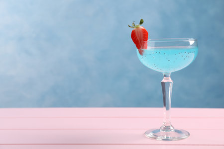 Tasty light blue cocktail on pink wooden table, space for textの写真素材