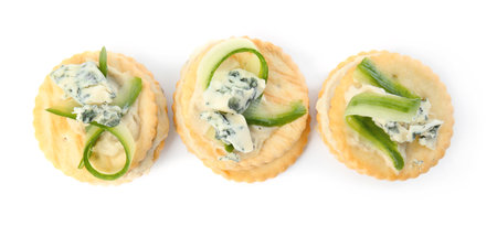 Delicious crackers with cheese and cucumber on white background, top viewの写真素材